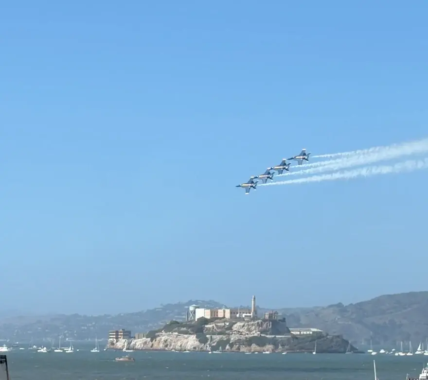 A short clip from the Surefront team: the Blue Angels crossing over Alcatraz and the barges off Fisherman's Wharf, then passing the Ferris wheel with the Golden Gate Bridge on the horizon behind it, during San Francisco Fleet Week.